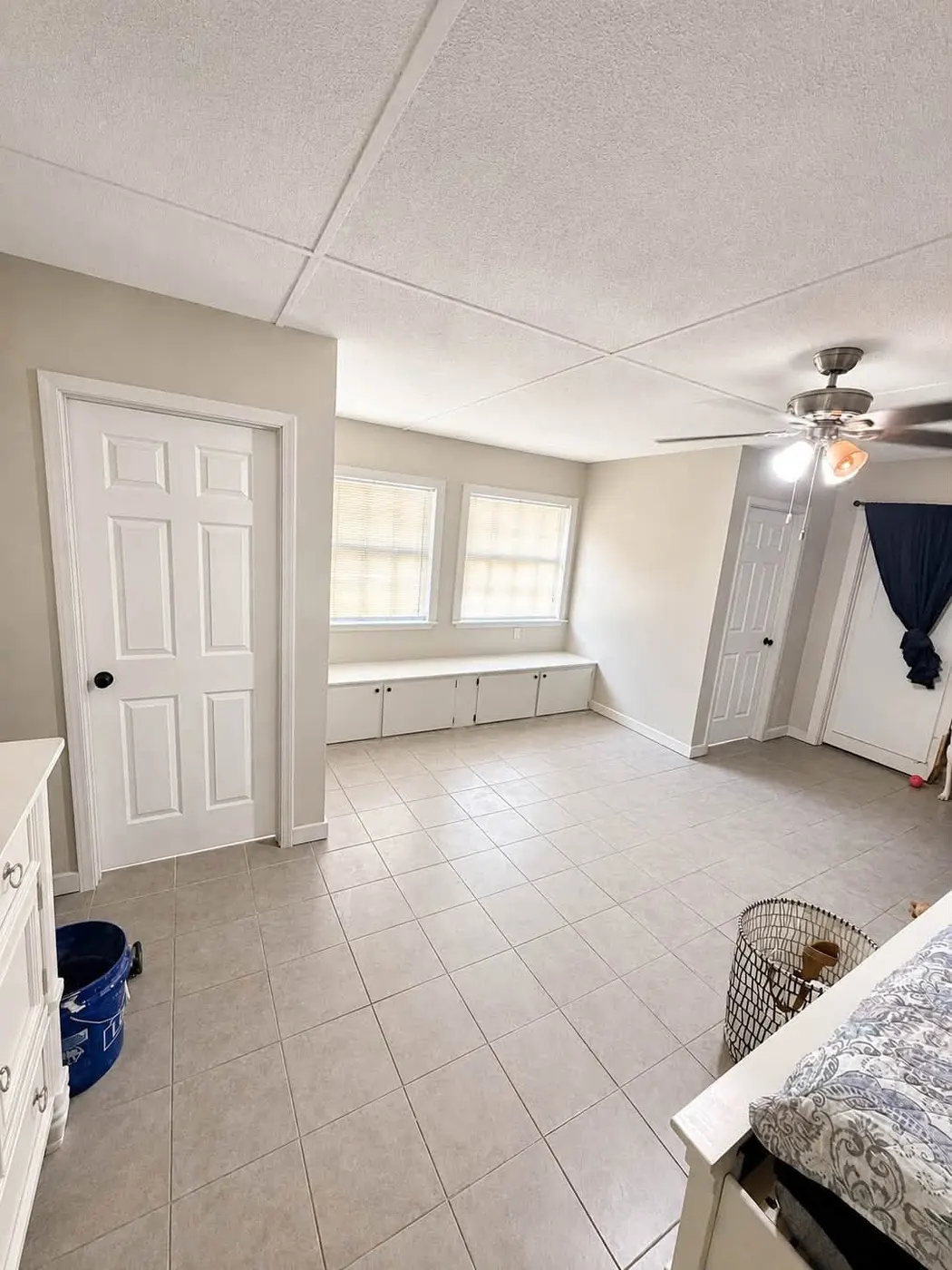 Large room with new ceramic tile flooring and a built-in window bench