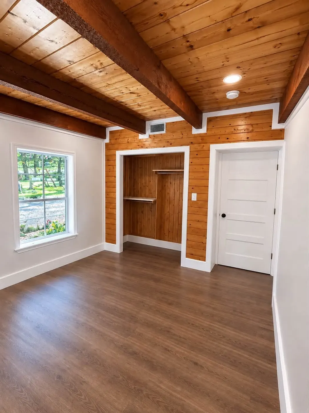 TrueCraft bedroom renovation with exposed wood beams, pine shiplap wall, and new plank floors