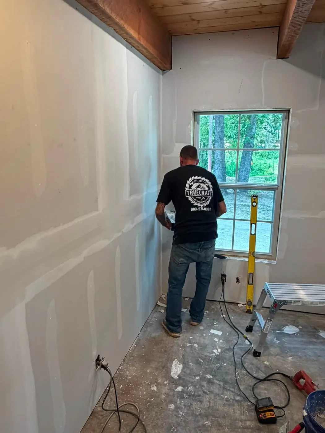 TrueCraft team member in a company shirt working on a home renovation